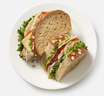 Turkey Avocado Sandwich with Havarti, tomatoes, lettuce and mayo on multigrain bread