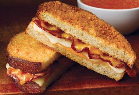 The Great Grilled Cheese with Bacon with melted cheese on Parmesan-crusted sliced sourdough