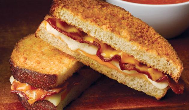 The Great Grilled Cheese with Bacon with melted cheese on Parmesan-crusted sliced sourdough