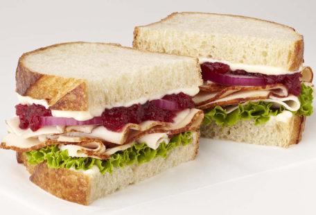 Turkey Cranberry Sandwich with, red onion, lettuce and mayo on sliced sourdough