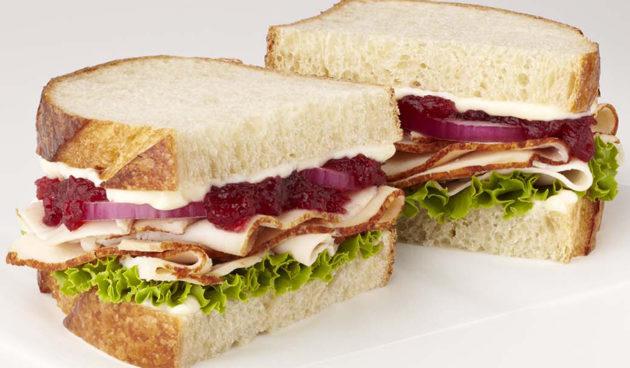 Turkey Cranberry Sandwich with, red onion, lettuce and mayo on sliced sourdough