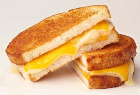 The Great Grilled Cheese Sandwich with melted Havarti and sharp cheddar cheese on parmesan-crusted sliced sourdough