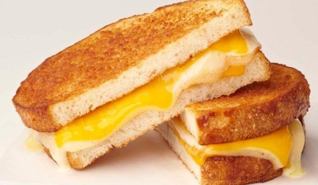 The Great Grilled Cheese Sandwich with melted Havarti and sharp cheddar cheese on parmesan-crusted sliced sourdough