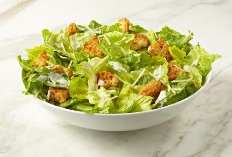Caesar Salad with sourdough croutons and Parmesan cheese in a bowl