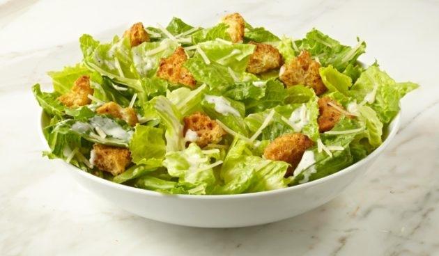 Caesar Salad with sourdough croutons and Parmesan cheese in a bowl