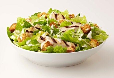 Caesar Salad with chicken, sourdough croutons and Parmesan cheese in a bowl