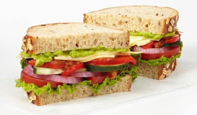 California Veggie Sandwich with smashed avocado, Havarti, red peppers, cucumber, lettuce, red onion, tomatoes, sun-dried tomato spread and balsamic vinaigrette on sliced multigrain