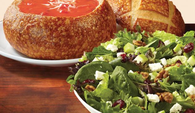 Soup and Salad Combo with tomato soup in a sourdough bread bowl and a spring salad