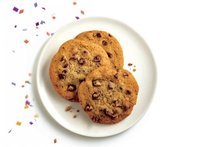 Chocolate chip cookies on plate with party confetti falling