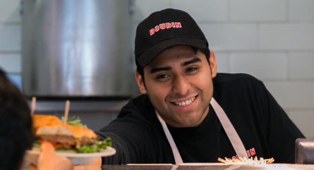 Boudin employee serving food