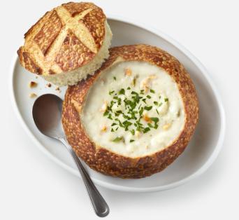 Clam chowder in a Sourdough bread bowl on a plate