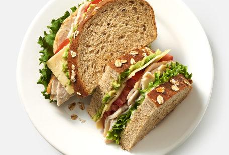 Turkey Avocado Sandwich with Havarti, tomatoes, lettuce and mayo on multigrain bread
