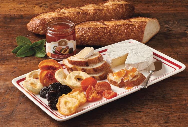 Sourdough baguettes, French Brie, peach chipotle and dried mixed fruit assortment on a tray