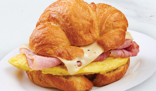 Ham & Swiss on Croissant Breakfast Sandwich on marble counter