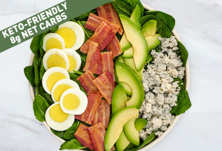 Keto Spinach Salad with 8g Net Carbs on Marble Surface
