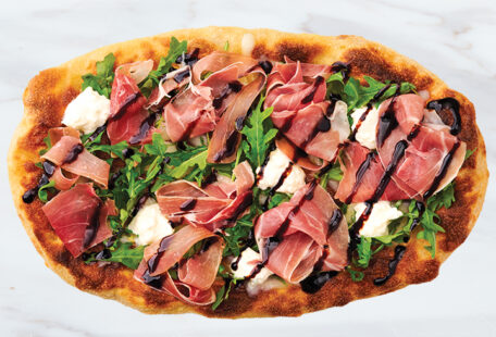 Prosciutto Bianca Pinsa Pizza on Marble Surface