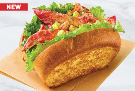 Lobster Roll on parchment on stone surface