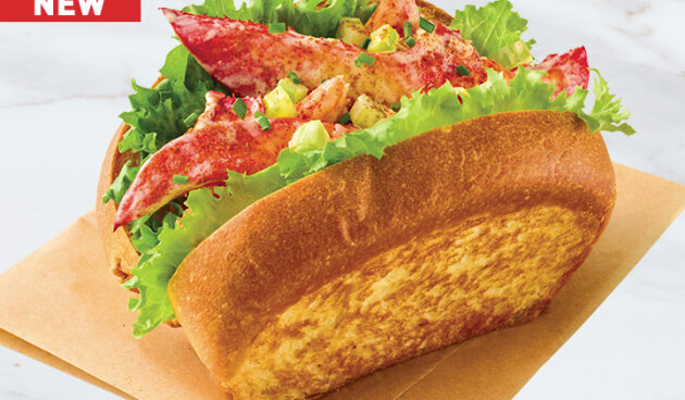 Lobster Roll on parchment on stone surface